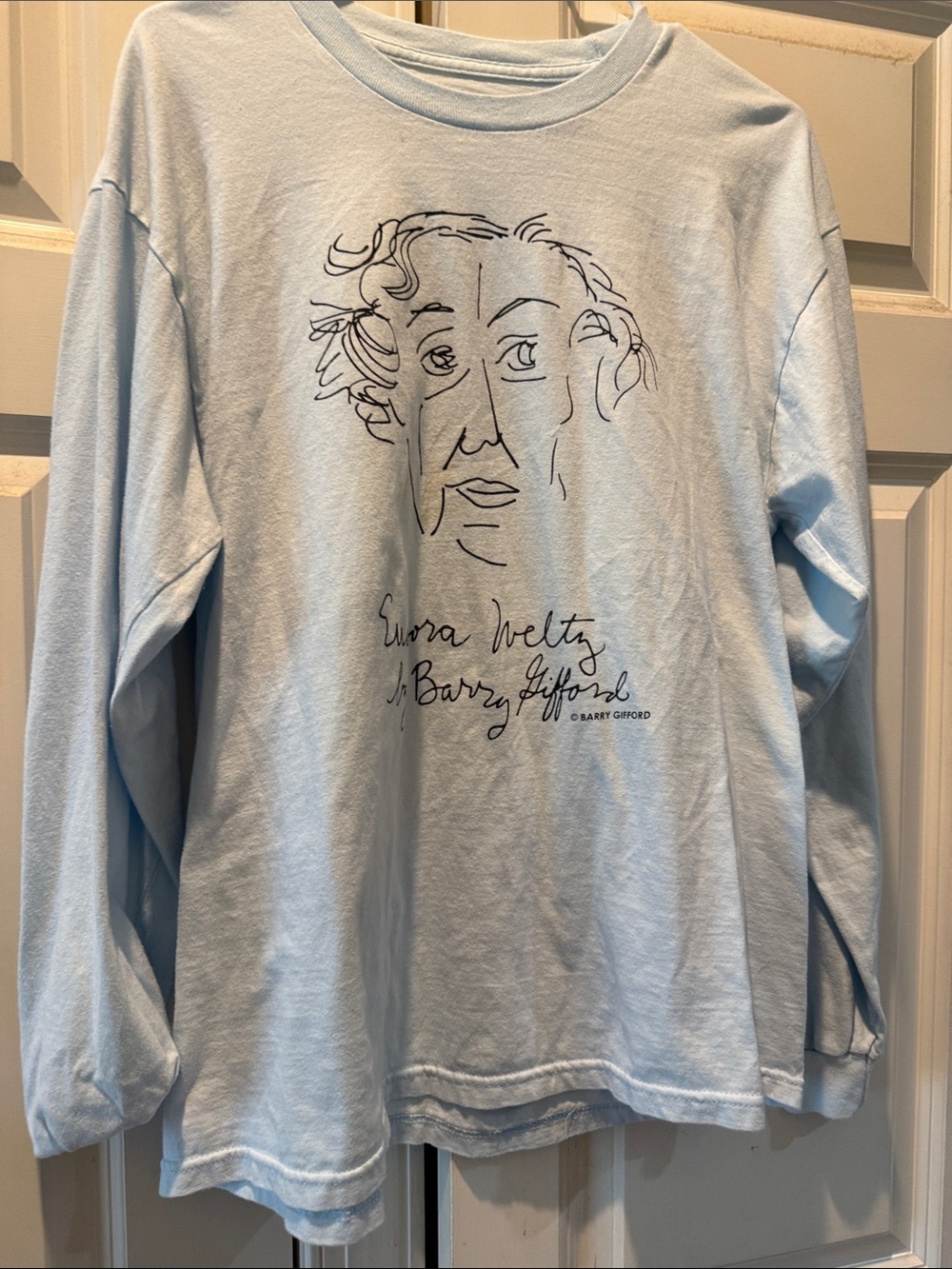 Light Blue Graphic Long Sleeve Tee with Line Art face of Eudora Welty.